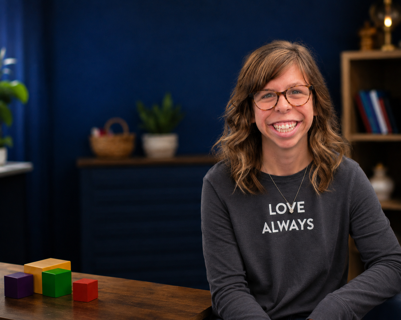 Bella smiling in a Love Always sweatshirt